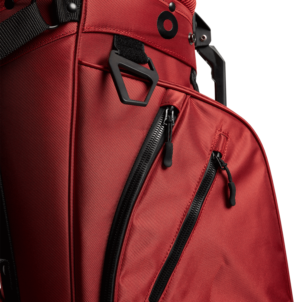 J.Lindeberg JL Flare golf bag in Bossa Nova red, close-up of accessory pockets and hardware